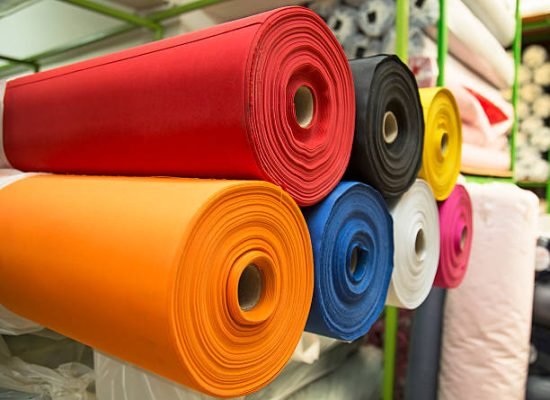 Colorful material fabric rolls in warehouse